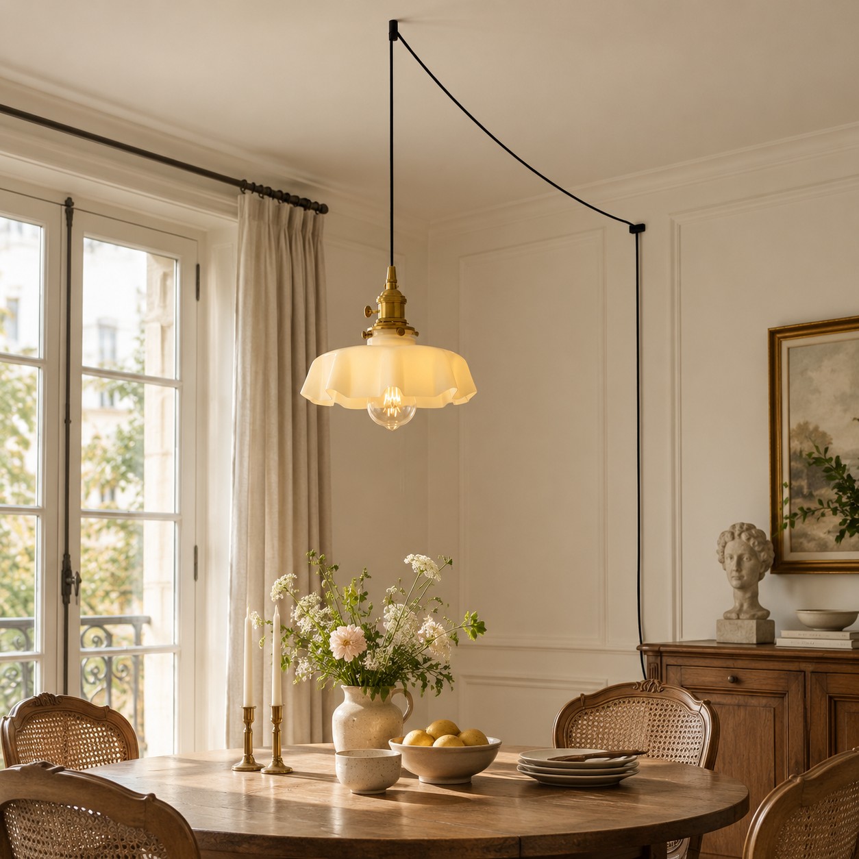 White flower glass pendant light above a wooden dining table