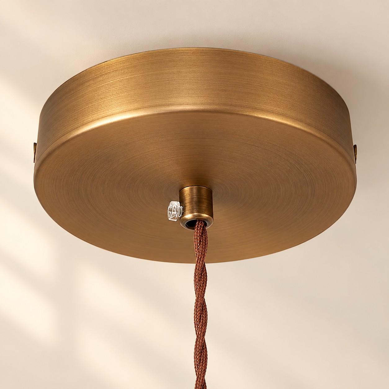 Brushed brass ceiling canopy with twisted fabric cord