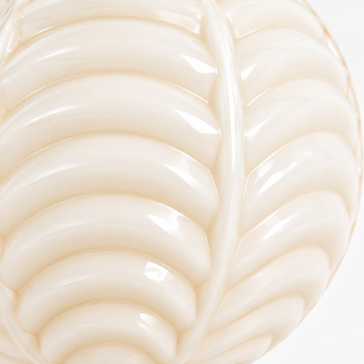 Close-up of cream milk glass with raised ribs and a center vein