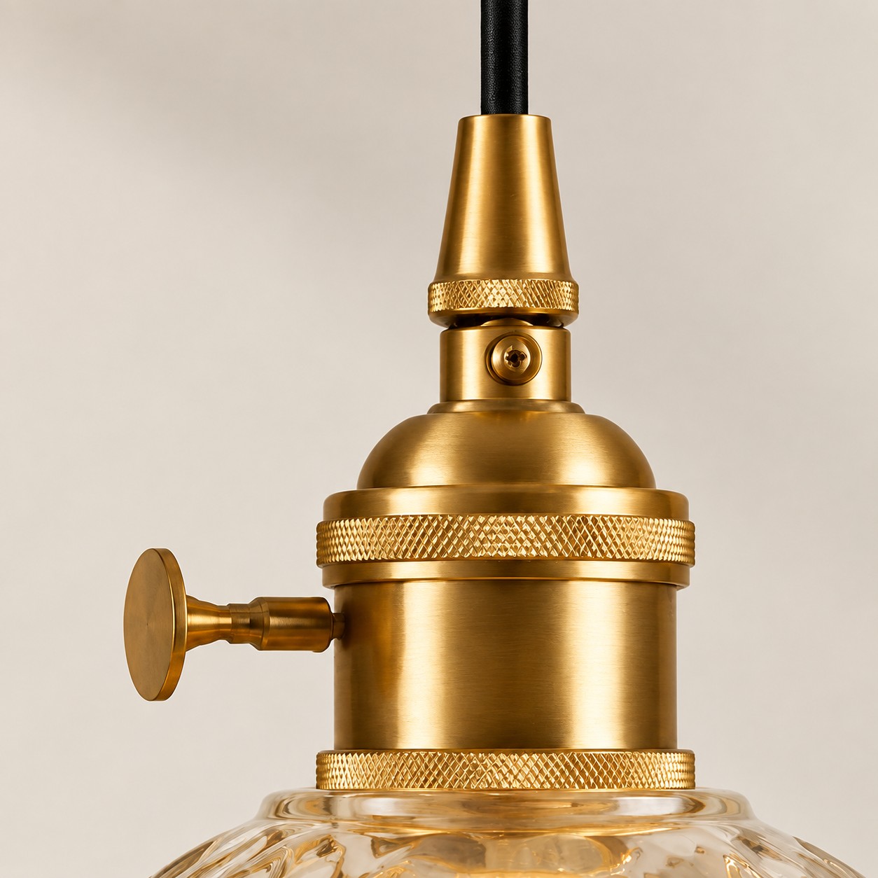 Gold-tone metal lamp holder with textured rings and a side key detail