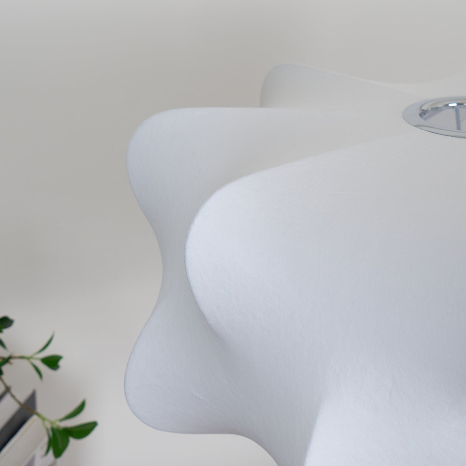 Close-up of the white pendant shade showing its fine texture and softly curved edges