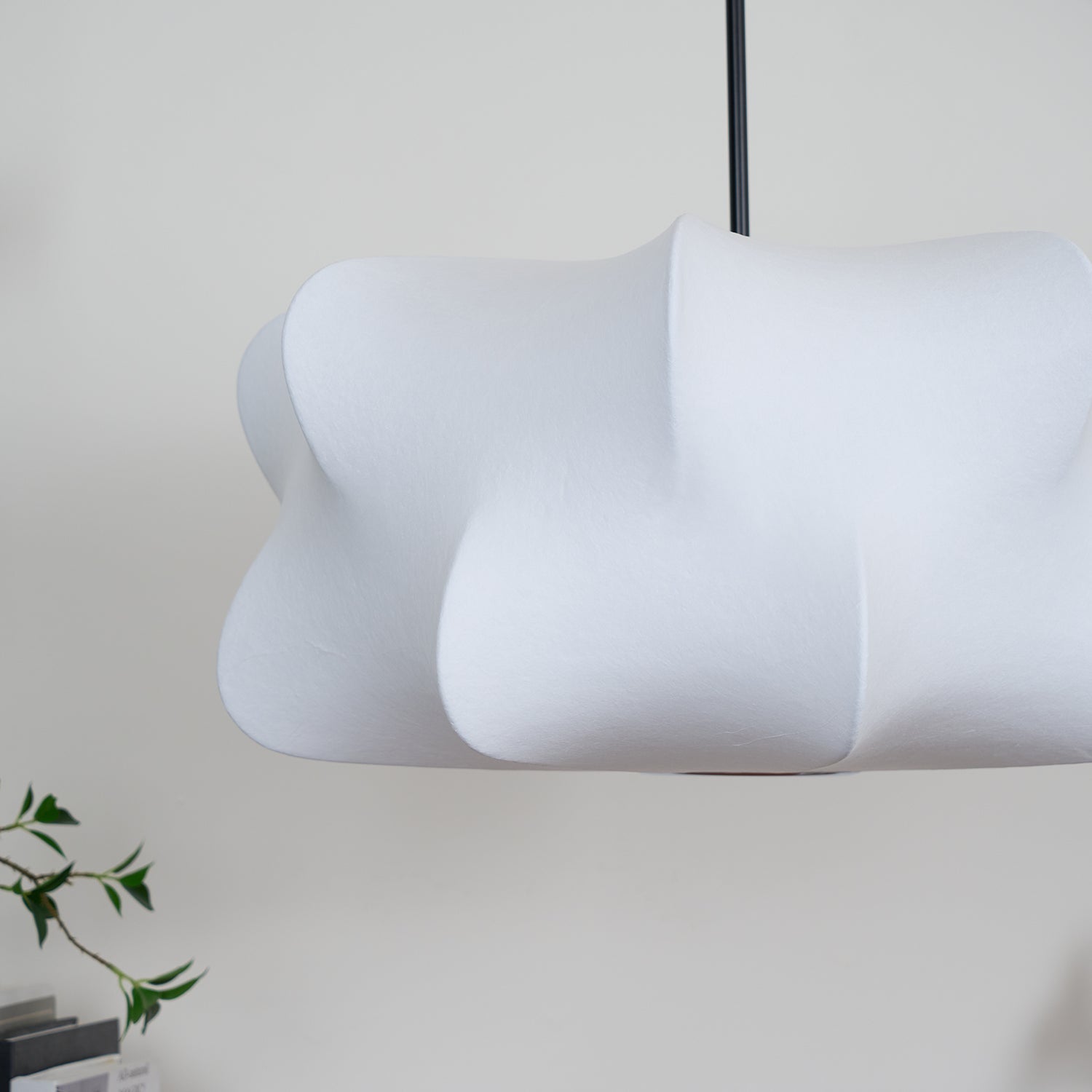 Unlit white pendant showing its softly textured shade and sculptural contours