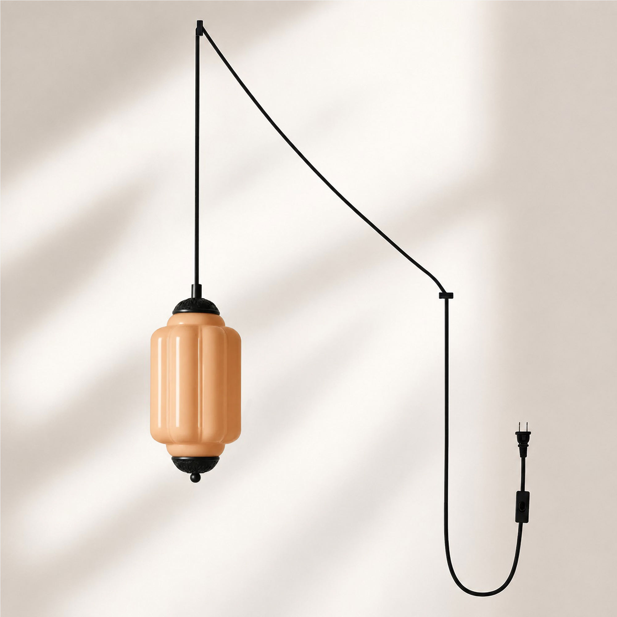 Black finish pendant with orange glass shade