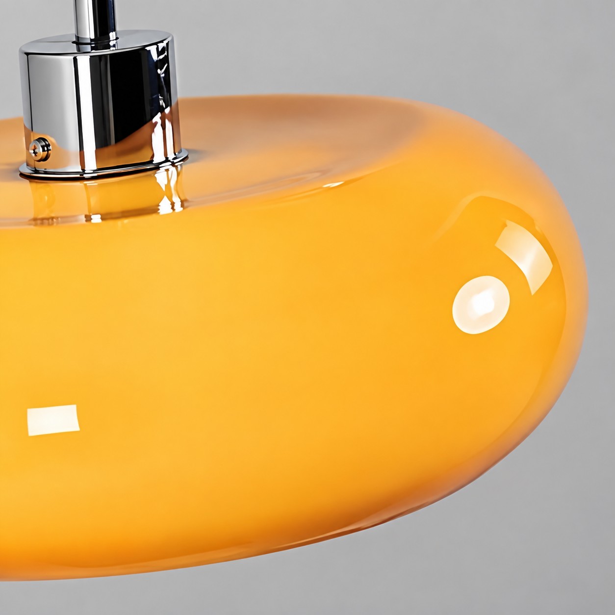 Close-up of the orange glass shade and metal top