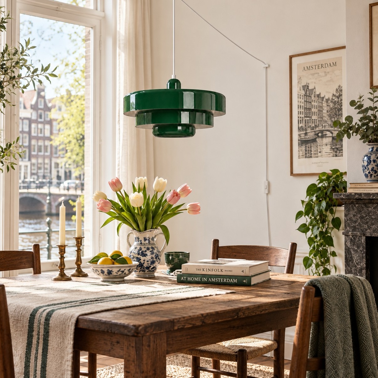 Dark green pendant light above a wooden dining table