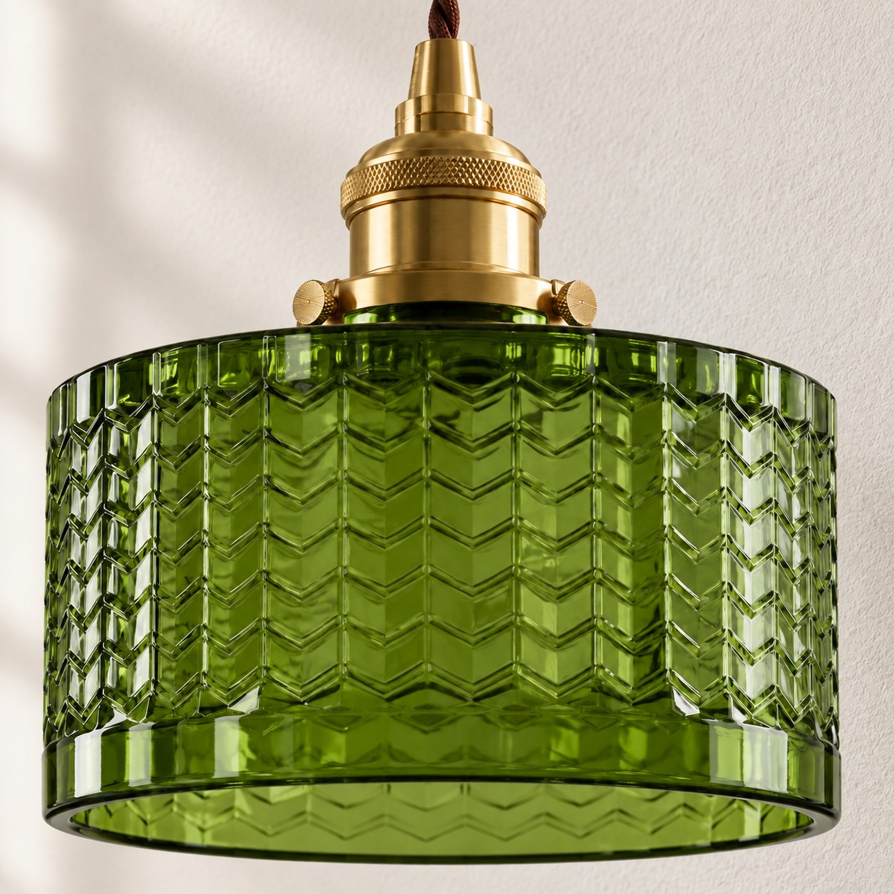 Close-up of the complete olive-green chevron glass shade and brass lamp holder