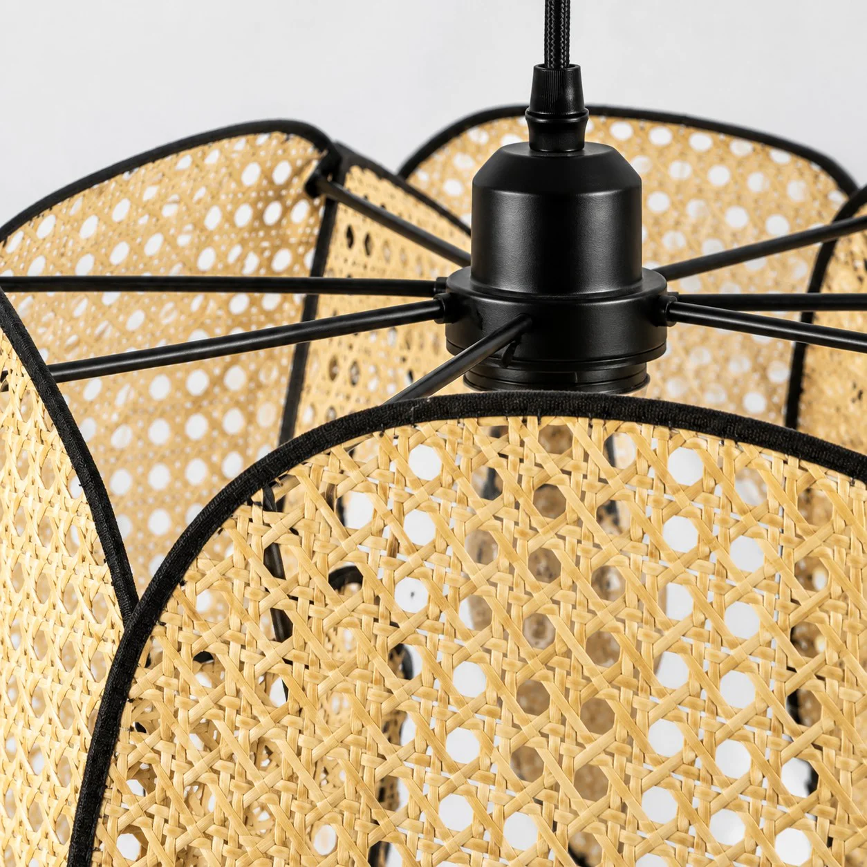 Black metal hub and supporting rods behind layered bamboo screens